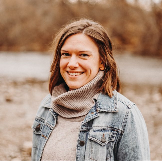 woman with brown hair wearing a jean jacket