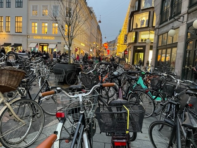Bike racks full of parked bikes in a city