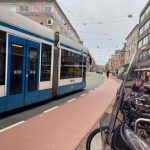 A bus, bike lane, and bike parking in Amsterdam