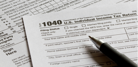 1040 tax form and a pen