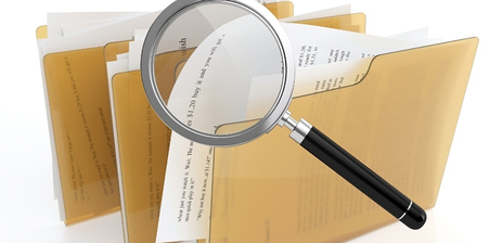 file folders and a magnifying glass