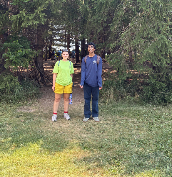 Two youths in a forest looking at the camera with smiles